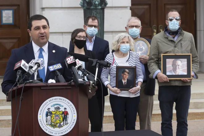 Attorney General Josh Kaul speaks Tuesday, April 27, 2021 at the State Capitol in Madison as he announces the Wisconsin Department of Justice will open a statewide review of reports of clergy abuse. In the background is the family of Nate Lindstrom, who killed himself at age 45. Lindstrom said that as a teen, he was abused by three priests at St. Norbert Abbey in De Pere. (Mark Hoffman/Milwaukee Journal Sentinel)