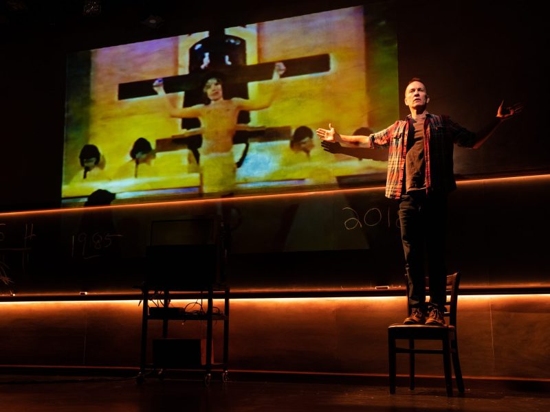 Jay Sefton in front of crucifixion Jay Sefton performing in "Unreconciled" in front of his grade-school role as Jesus