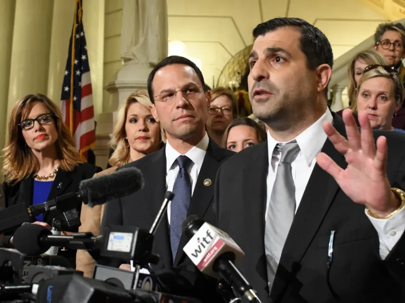 Then-State Rep. Mark Rozzi (D., Berks) speaks at a news conference at the Pennsylvania State Capitol in October 2018. He is flanked by then-Attorney General Josh Shapiro, lawmakers, and abuse victims. (Mark Levy/AP)