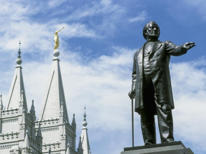Statue of Brigham Young offset by the spires of the Mormon temple in Salt Lake City